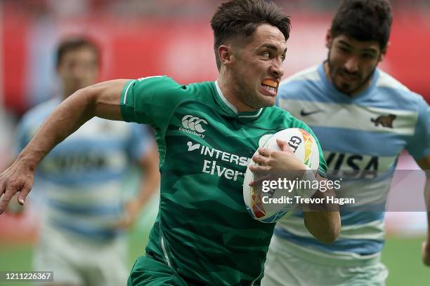 Greg O'Shea of Ireland breaks away from German Shulz of Argentina to score during their rugby sevens match at BC Place on March 08, 2020 in...