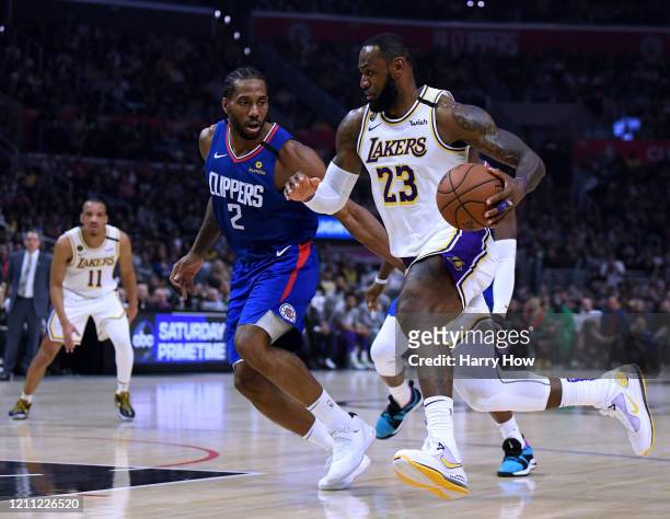 LeBron James of the Los Angeles Lakers drives to the basket on Kawhi Leonard of the LA Clippers during a 112-103 Lakers win at Staples Center on...