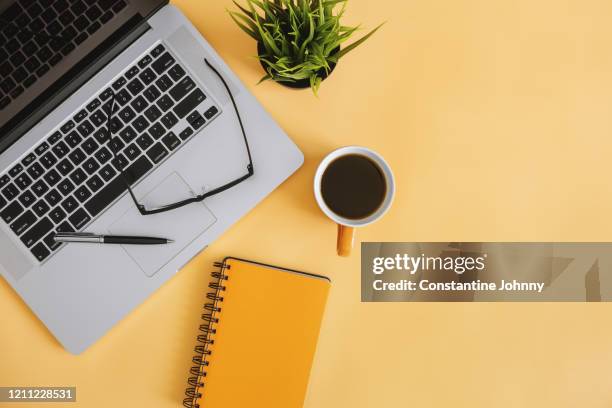 notebook and laptop on work desk - desktop overhead view stock pictures, royalty-free photos & images