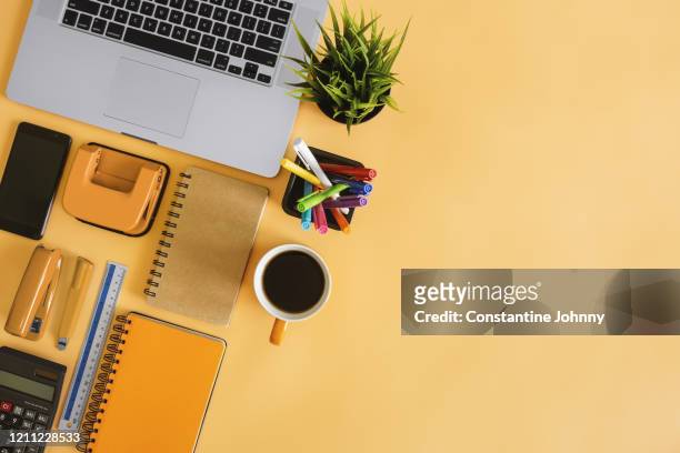top view of laptop and office supply items on orange desk - knolling tools stock pictures, royalty-free photos & images