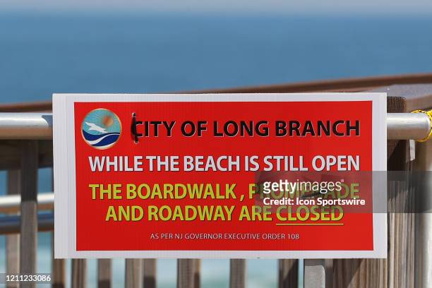 General view of a sign letting people know that while in Long Branch the beach is still open the boardwalk, promanade and roadway are closed due to...