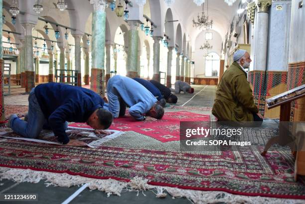 Muslim devotees taking part in Ramadan afternoon prayers at a social distance during the covid 19 crisis. Observing Ramadan during a...