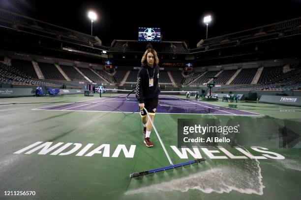 Courtmaster Jeffrey Brooker cleans the center court at the Indian Wells Tennis Garden on March 08, 2020 in Indian Wells, California. The BNP Paribas...