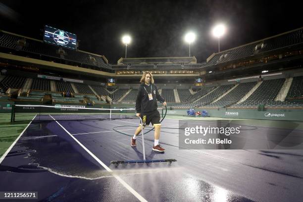 Courtmaster Jeffrey Brooker cleans the center court at the Indian Wells Tennis Garden on March 08, 2020 in Indian Wells, California. The BNP Paribas...