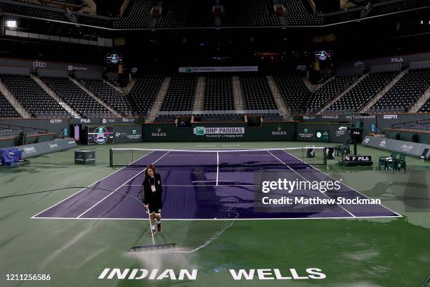 Courtmaster Jeffrey Brooker cleans the center court at the Indian Wells Tennis Garden on March 08, 2020 in Indian Wells, California. The BNP Paribas...