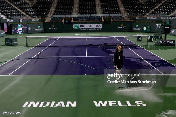 Courtmaster Jeffrey Brooker cleans the center court at the Indian Wells Tennis Garden on March 08, 2020 in Indian Wells, California. The BNP Paribas...