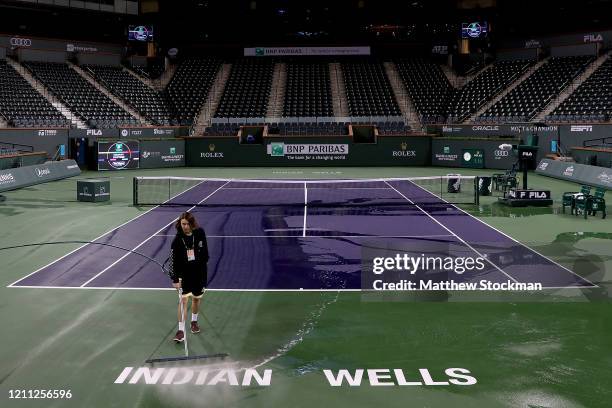 Courtmaster Jeffrey Brooker cleans the center court at the Indian Wells Tennis Garden on March 08, 2020 in Indian Wells, California. The BNP Paribas...