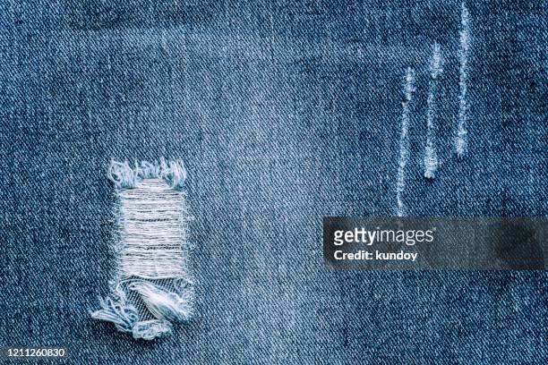 abstract background from blue denim and torn. retro and vintage. picture for add text message. backdrop for design art work. - zerrissene jeans stock-fotos und bilder