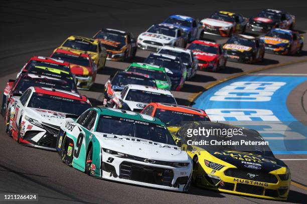 Chase Elliott, driver of the UniFirst Chevrolet, and Brad Keselowski, driver of the Alliance Parts Ford, lead at a restart during the NASCAR Cup...