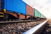 Train wagons carrying cargo containers for shipping companies.