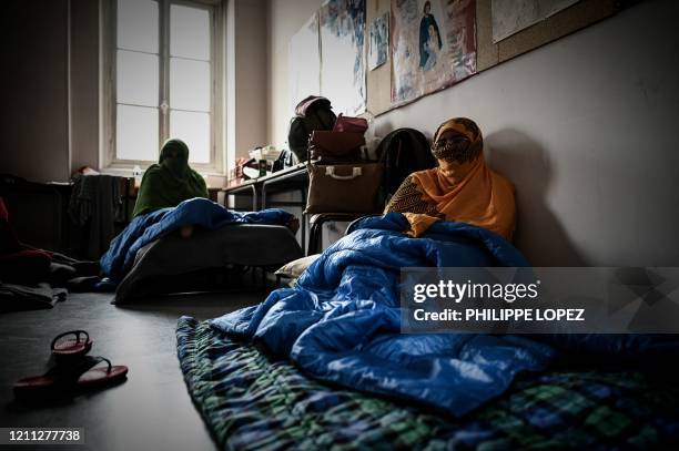 Asylum seekers from Somalia Zahra and Saadia sit together at their temporary shelter provided by a parish church in Aubervilliers, in the suburbs of...