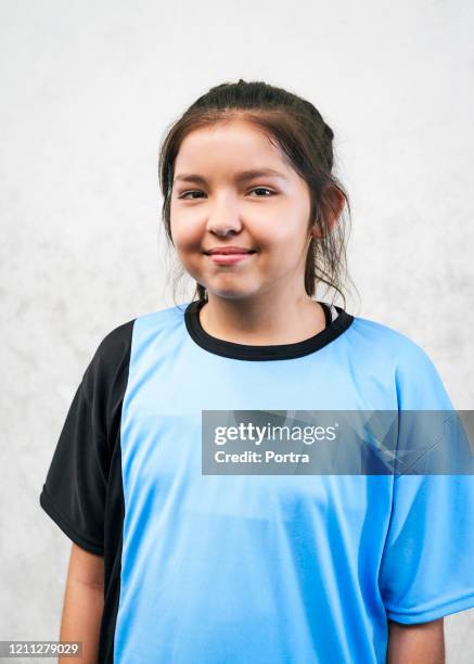 smiling soccer girl against white wall - argentina girls stock pictures, royalty-free photos & images