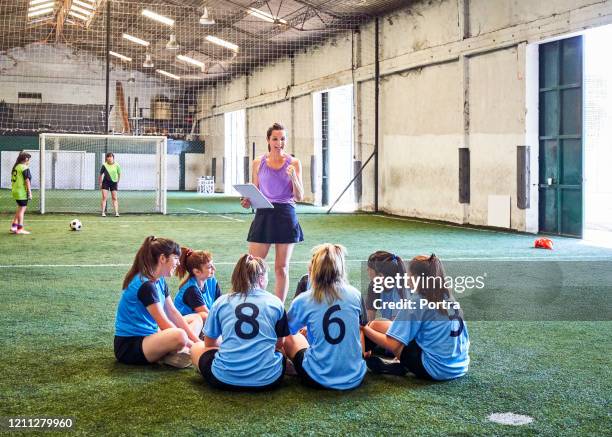 female soccer coach cheering team at court - coach cheering stock pictures, royalty-free photos & images