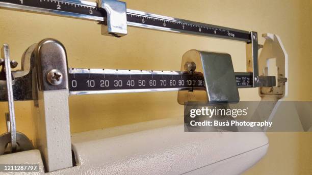 detail of old fashioned physician's mechanical beam scale with with height rod - lb stock pictures, royalty-free photos & images