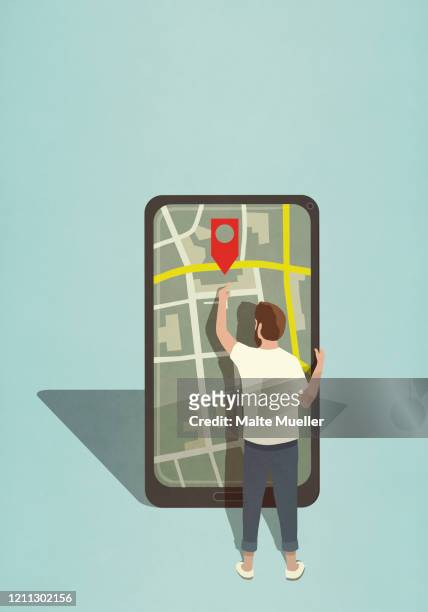 man reaching for map pin icon on large smart phone - stecknadel stock-grafiken, -clipart, -cartoons und -symbole
