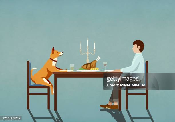 man and dog enjoying candlelight dinner at table - tierfreundschaften stock-grafiken, -clipart, -cartoons und -symbole