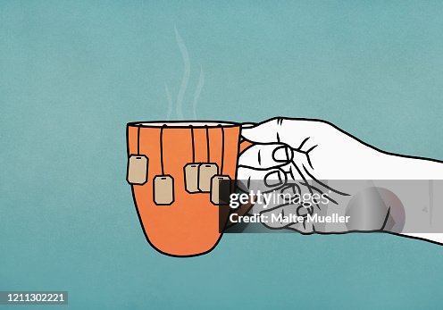 Hand holding mug with many tea bags Hand holding mug with many tea bags