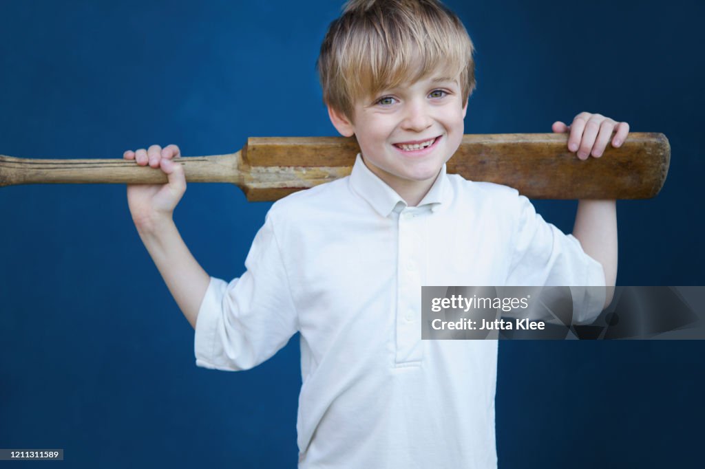 Portrait smiling boy with cricket bat