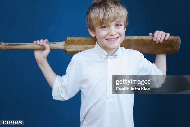 portrait smiling boy with cricket bat - cricket player portrait stock pictures, royalty-free photos & images