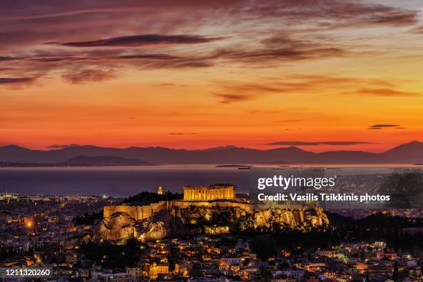 the athens acropolis after a winter sunset - akropolis stock-fotos und bilder