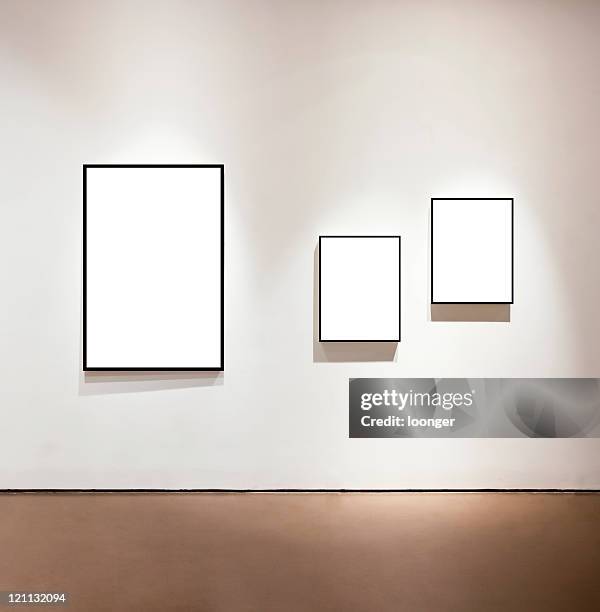 blank frames on the wall at art gallery - art fair stockfoto's en -beelden