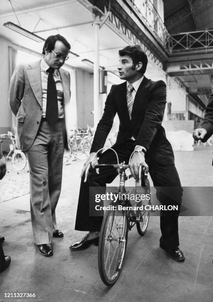 Raymond Poulidor en compagnie de François Gadet-Clet, PDG de Manufrance, essaye un vélo de course pour enfant dans l'usine de Saint Etienne le 8 mars...