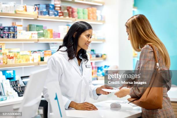 female customer asking pharmacist at checkout - pharmacist explaining stock pictures, royalty-free photos & images