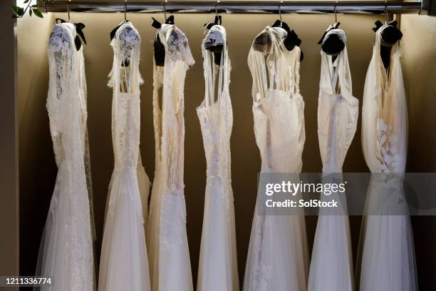 dresses in bridal store - wedding dress on hanger stock pictures, royalty-free photos & images