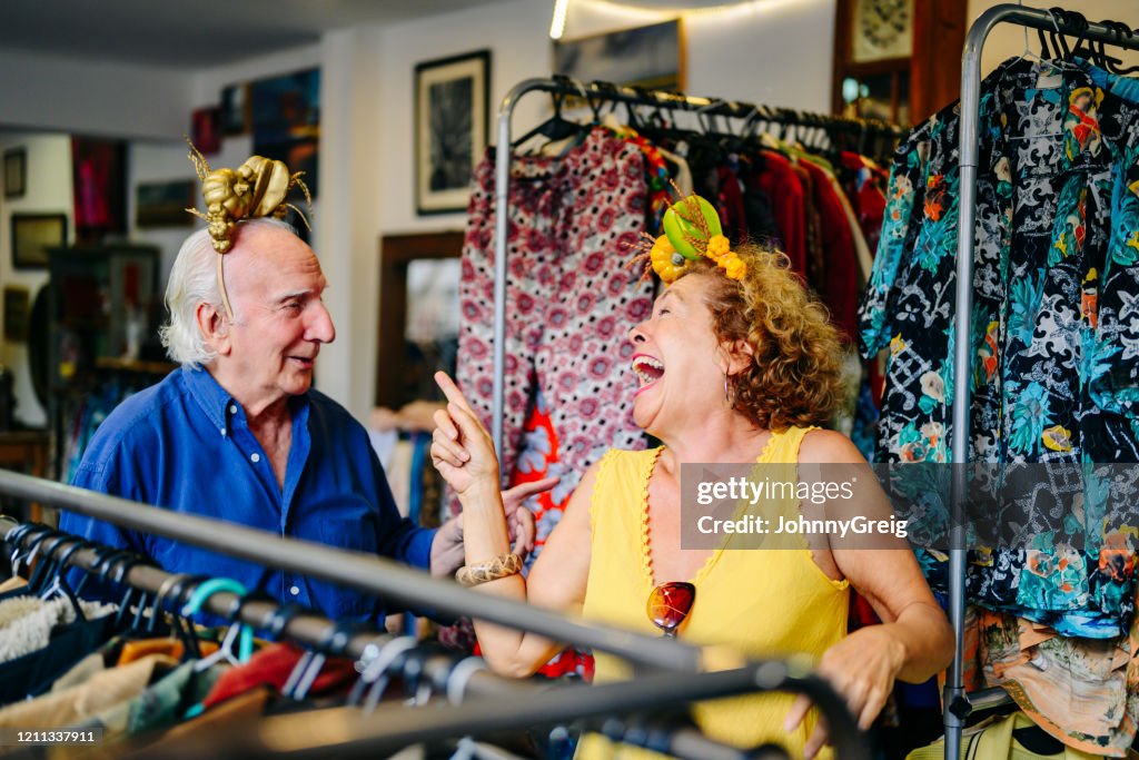 Fun seniors finding headband treasures in secondhand shop