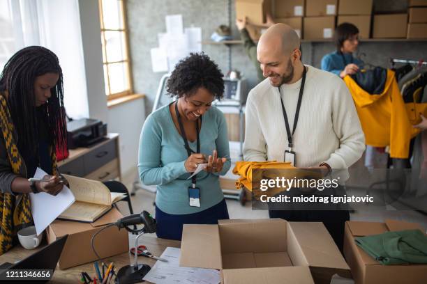 Clothes Packing In Store Packing Clothes In Boxes Photos and Premium High Res Pictures - Getty ...