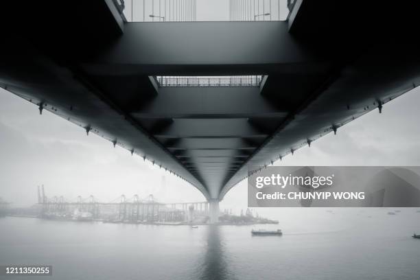 hong kong port and stonecutters bridge - bridge fog stock pictures, royalty-free photos & images