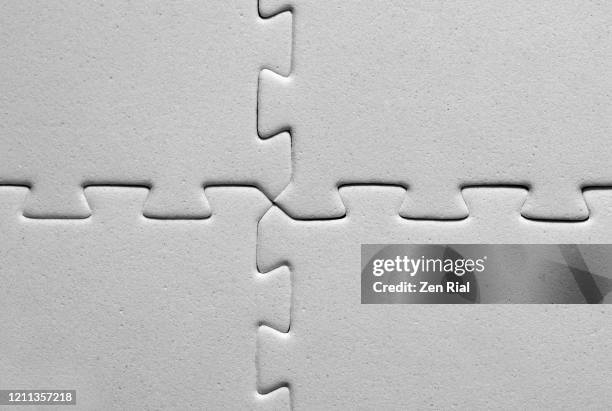 interlocked four white jigsaw pieces - interlocked stock-fotos und bilder