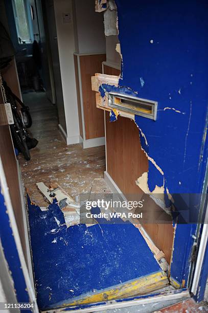 The smashed front door of a property in Brixton after Metropolitan police officers forced entry to the property during an early morning raid in...