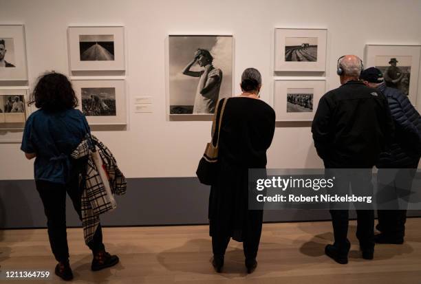 Viewers take in the images of documentary photographer Dorothea Lange at an exhibition in the Museum of Modern Art in New York City on March 7, 2020....