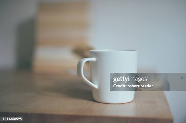 white mug on table - kaffeepause stock-fotos und bilder