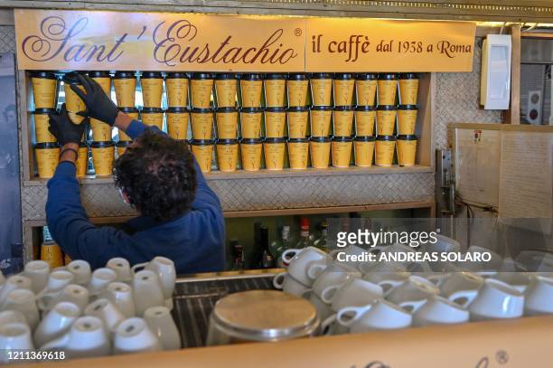 Owner of the Sant'Eustachio cafe, Raimondo Ricci, sorts takeaway coffe cups in his establishment on April 30, 2020 in Rome, during the country's...