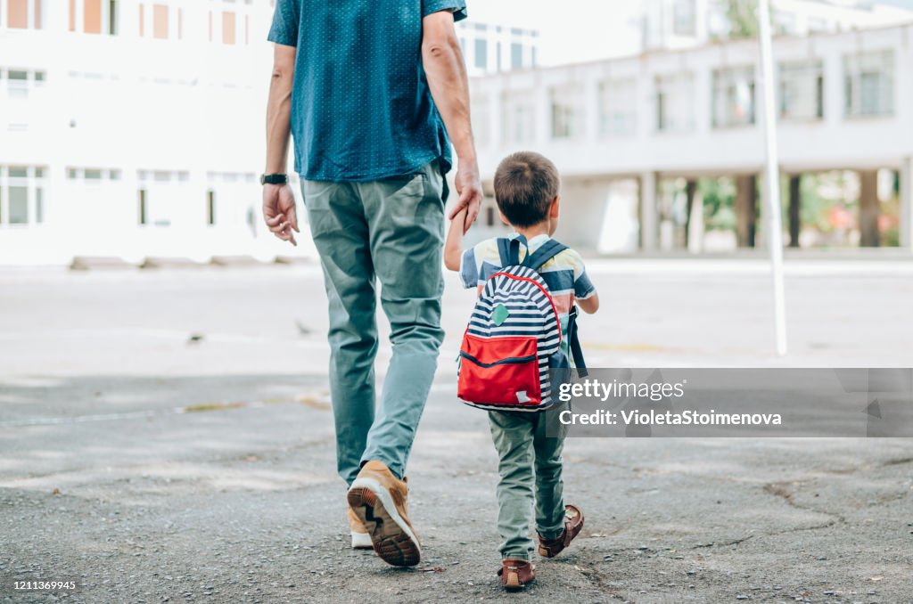 Father and son going to school.