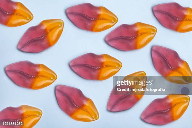 candy lips on a blue background - candy lips stock pictures, royalty-free photos & images