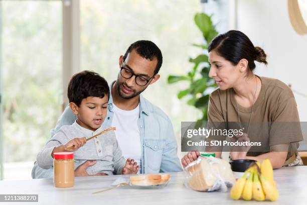 independent young boy prepares sandwich - peanut butter and jelly sandwich stock pictures, royalty-free photos & images