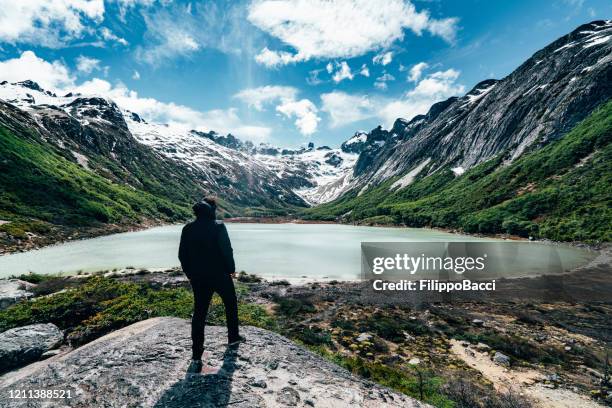 man admiring laguna esmeralda, emerald lake - ushuaia, patagonia - argentina - emerald green stock pictures, royalty-free photos & images