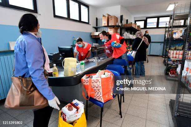 Needy people shop for free at a supermarket of Catholic social organization Caritas, called "Emporio della Solidarieta" on April 30, 2020 in Milan,...