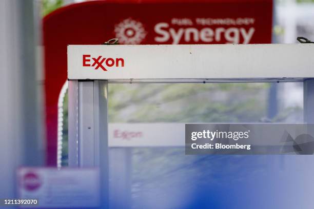 Signage is displayed on a fuel pump at an Exxon Mobil Corp. Gas station in Falls Church, Virginia, U.S., on Tuesday, April 28, 2020. Exxon is...