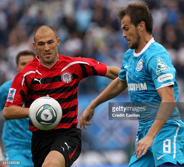 Danko Lazovic of FC Zenit St. Petersburg battles for the ball with Georgi Peev of FC Amkar Perm during the Russian Football League Championship match...