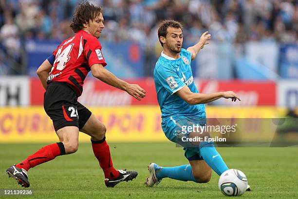 Danko Lazovic of FC Zenit St. Petersburg battles for the ball with Aleksei Popov of FC Amkar Perm during the Russian Football League Championship...
