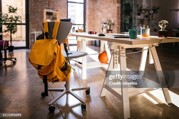 interior of modern office - backpack on chair stock pictures, royalty-free photos & images