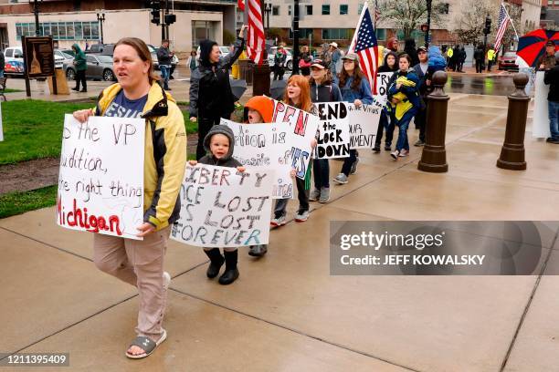 Demonstrators take part in an "American Patriot Rally," organized on April 30 by Michigan United for Liberty on the steps of the Michigan State...