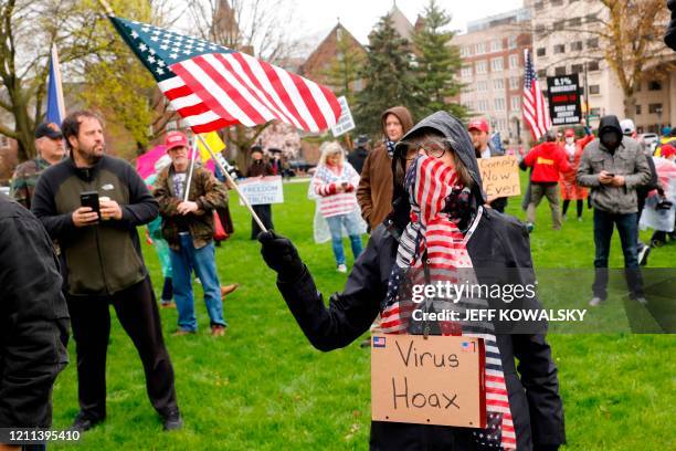 Demonstrators take part in an "American Patriot Rally," organized on April 30 by Michigan United for Liberty on the steps of the Michigan State...