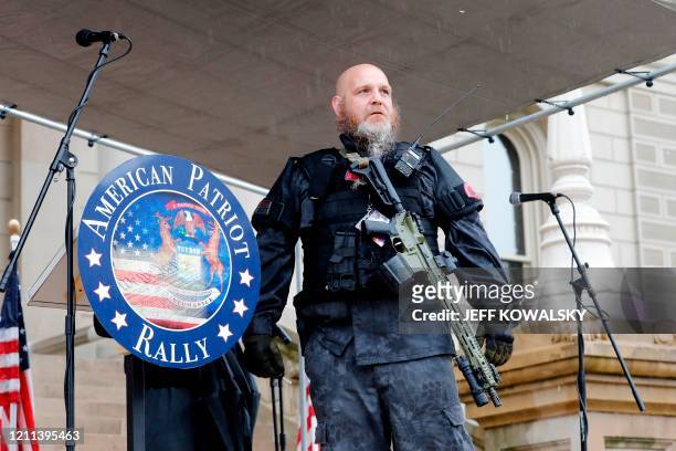 Armed protesters provide security as demonstrators take part in an "American Patriot Rally," organized on April 30 by Michigan United for Liberty on...