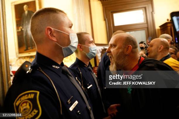 Protestors try to enter the Michigan House of Representative chamber and are being kept out by the Michigan State Police after the American Patriot...