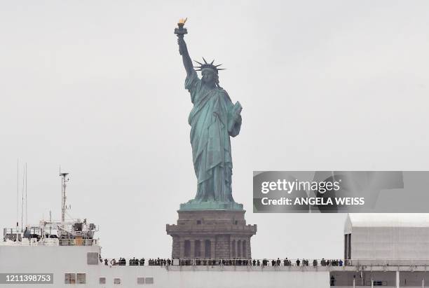 The hospital ship USNS Comfort passes the Statue of Liberty as its departs New York City April 30 after providing relief to the city's healthcare...